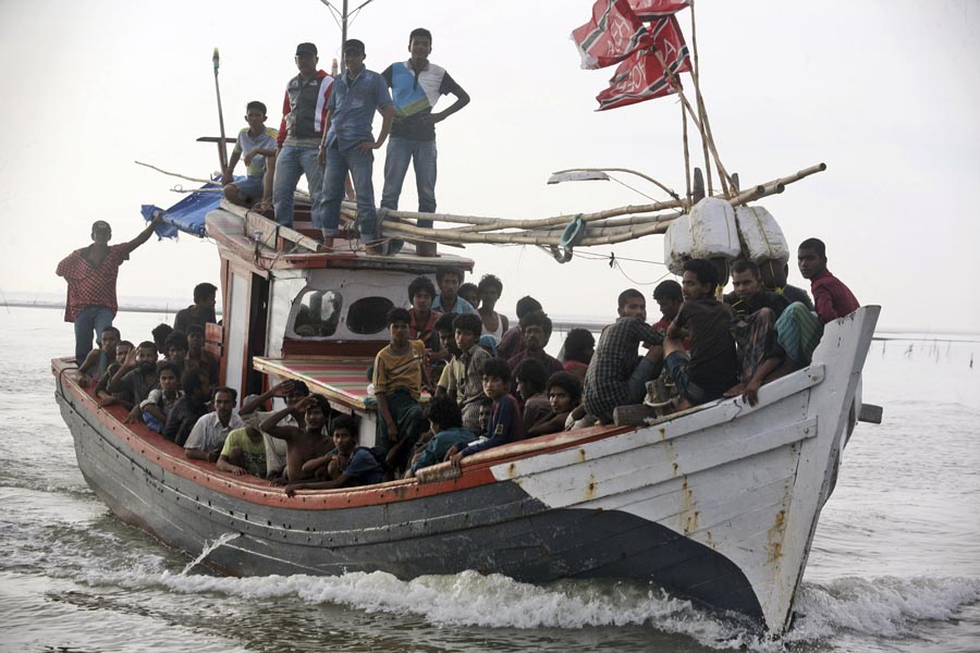 An Acehnese fishing boat full of rescued migrants approaches to dock in Simpang Tiga, Aceh province, Indonesia,  on Wednesday (AP photo)