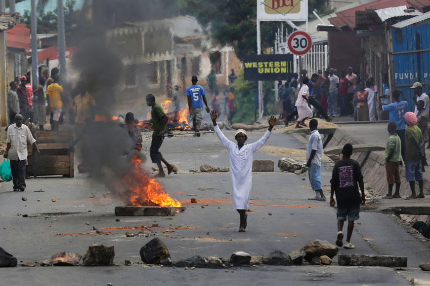 Protesters stand by a burning barricade in the Musaga neighbourhood of Bujumbura, Burundi, Thursday (AP photo)