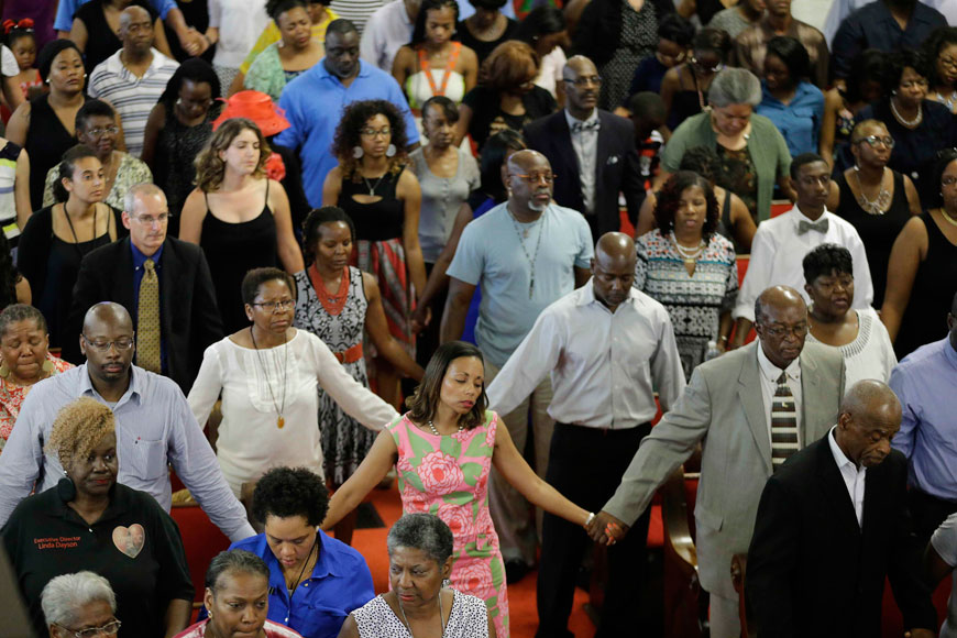 Parishioners hold hands and sing during services at the Emanuel African Methodist Episcopal Church in Charleston, South Carolina, on Sunday (Reuters photo)
