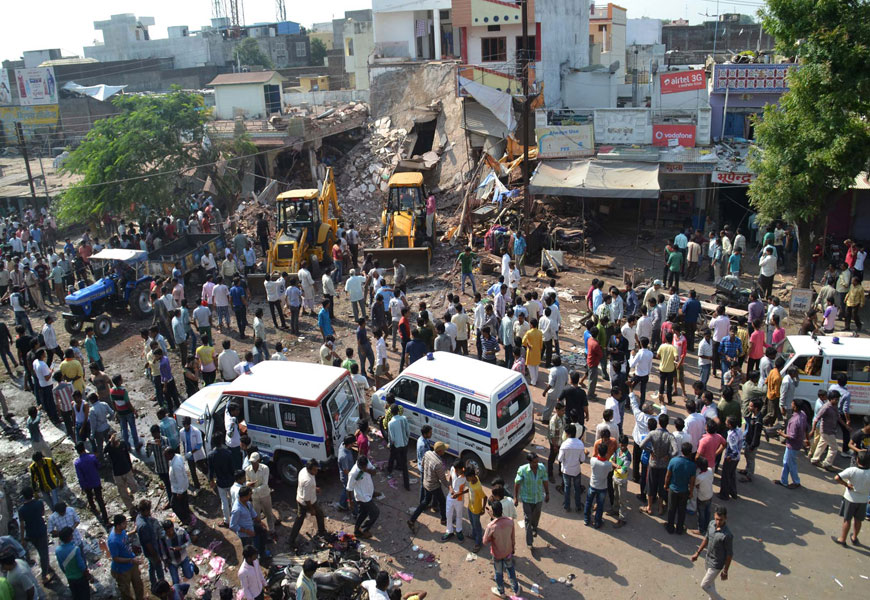 Earth movers work to clear debris at the site of an explosion in Petlawad, in the central Indian state of Madhya Pradesh, on Saturday (AP photo)