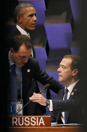 Russia’s Prime Minister Dmitry Medvedev (right) at the Asia-Pacific Economic Cooperation summit in Manila, on Thursday, while the US President Barack Obama passes by in the background (AP photo)