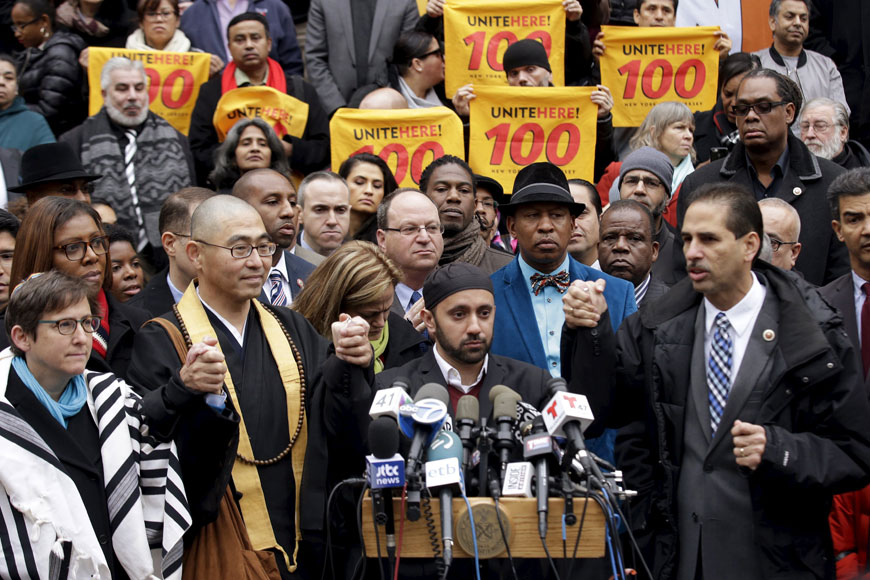 NYPD Chaplain Imam Khalid Latif (2nd right) leads an interfaith rally at New York’s City Hall in Manhattan on Wednesday. Republican presidential front-runner Donald Trump’s proposal to ban Mulims from entering the United States drew a growing wave of international criticism on Wednesday and cost him business in the Middle East (Reuters photo)