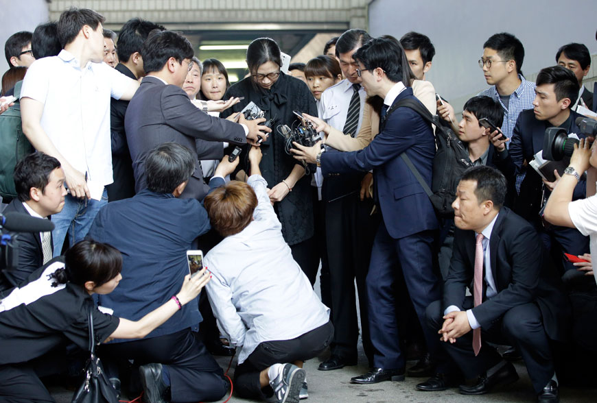 Former Korean Air executive Cho Hyun-ah (centre) is surrounded by reporters at the Seoul high court in Seoul, South Korea, Friday (AP photo)