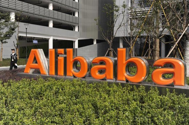 A security guard walks past a logo of Alibaba (Reuters file photo)