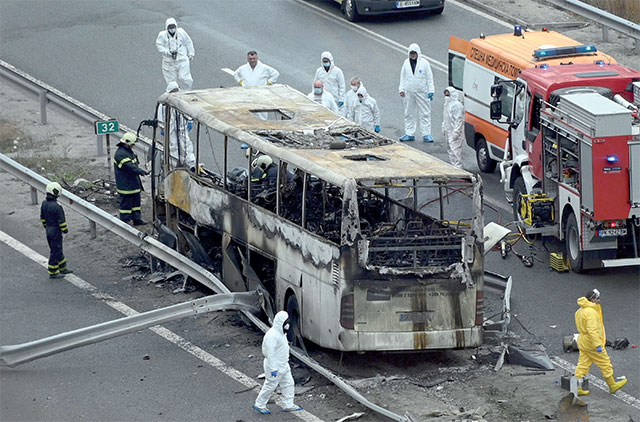 Officials work at the site of a bus accident, in which at least 46 people were killed, on a highway near the village of Bosnek, south of Sofia, on Tuesday (AFP photo)