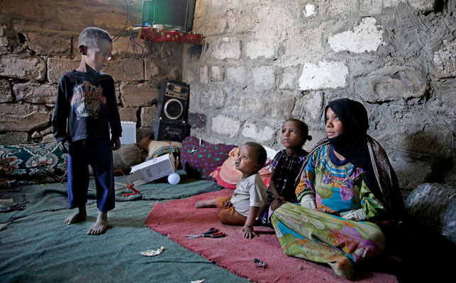 In this April 25 photo, the Hassan Mohammed Najy family, from a community who call themselves the ‘Muhammasheen’, or ‘the Marginalised’, who fled the city of Taiz due to the ongoing civil war, sit inside their home in a slum area of Sanaa, Yemen (AP photo)