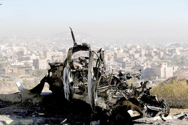 The wreckage of a vehicle is photographed at the site of air strikes in Sanaa, Yemen, on Tuesday (Reuters photo)
