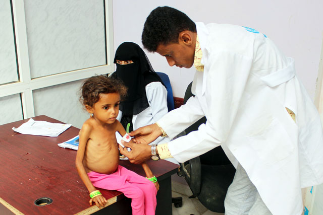 A Yemeni girl suffering from malnutrition is weighed at a clinic in Yemen's northern Hajjah province on Wednesday (AFP photo)