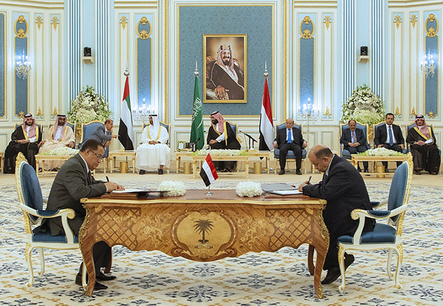 This handout photo by the Saudi Royal Palace on Tuesday shows Yemen's President Abed Rabbo Mansour Hadi (right) and Yemeni Southern Transitional Council Nasser Al Khabji sign documents during a peace-signing ceremony between the Yemeni government and the southern separatists in the capital Riyadh (AFP photo)